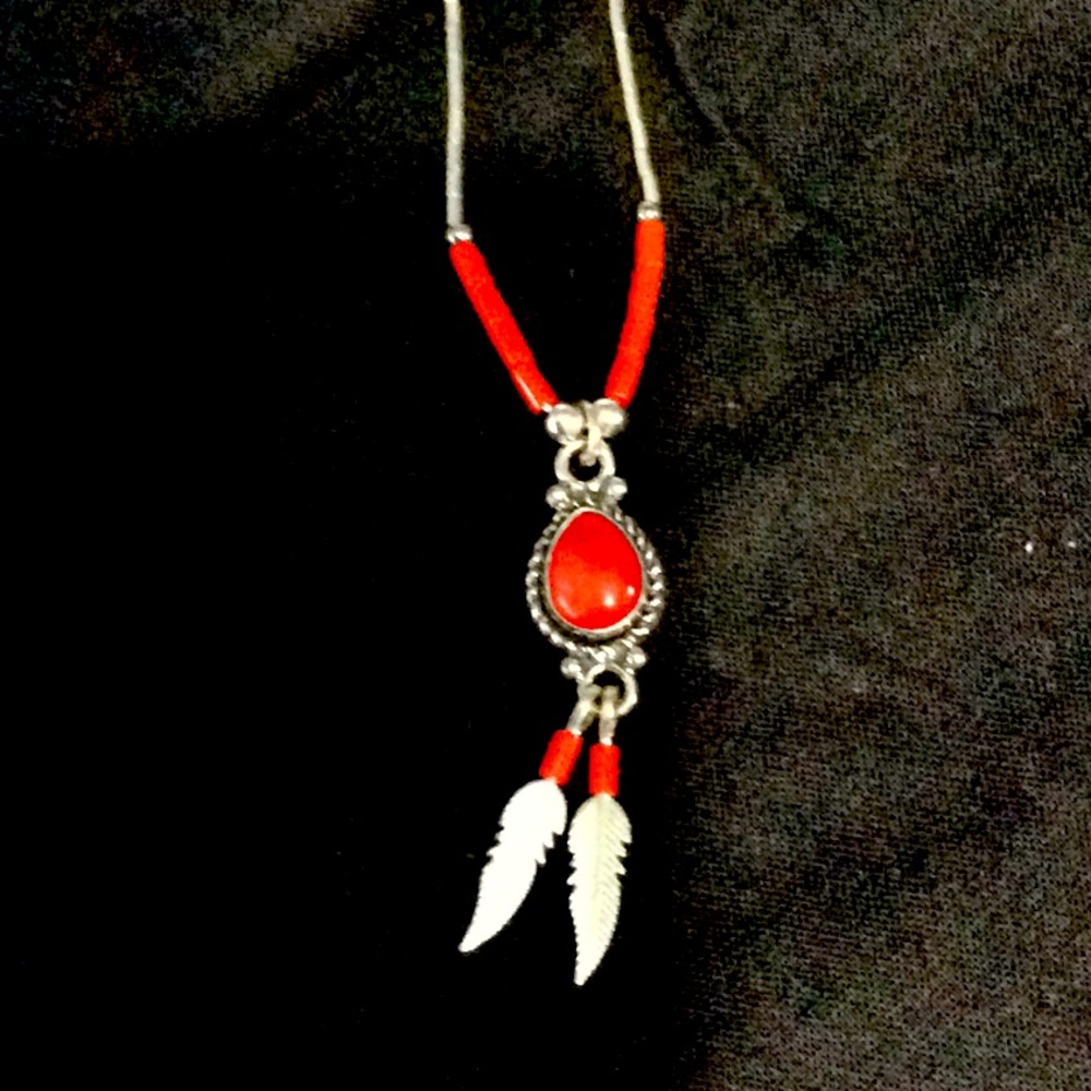 Sterling silver necklace with red accents.